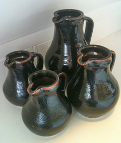 4 lead-glazed pitchers of different sizes